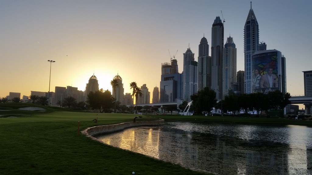 The setting sun lights up the final green on the Faldo Course.