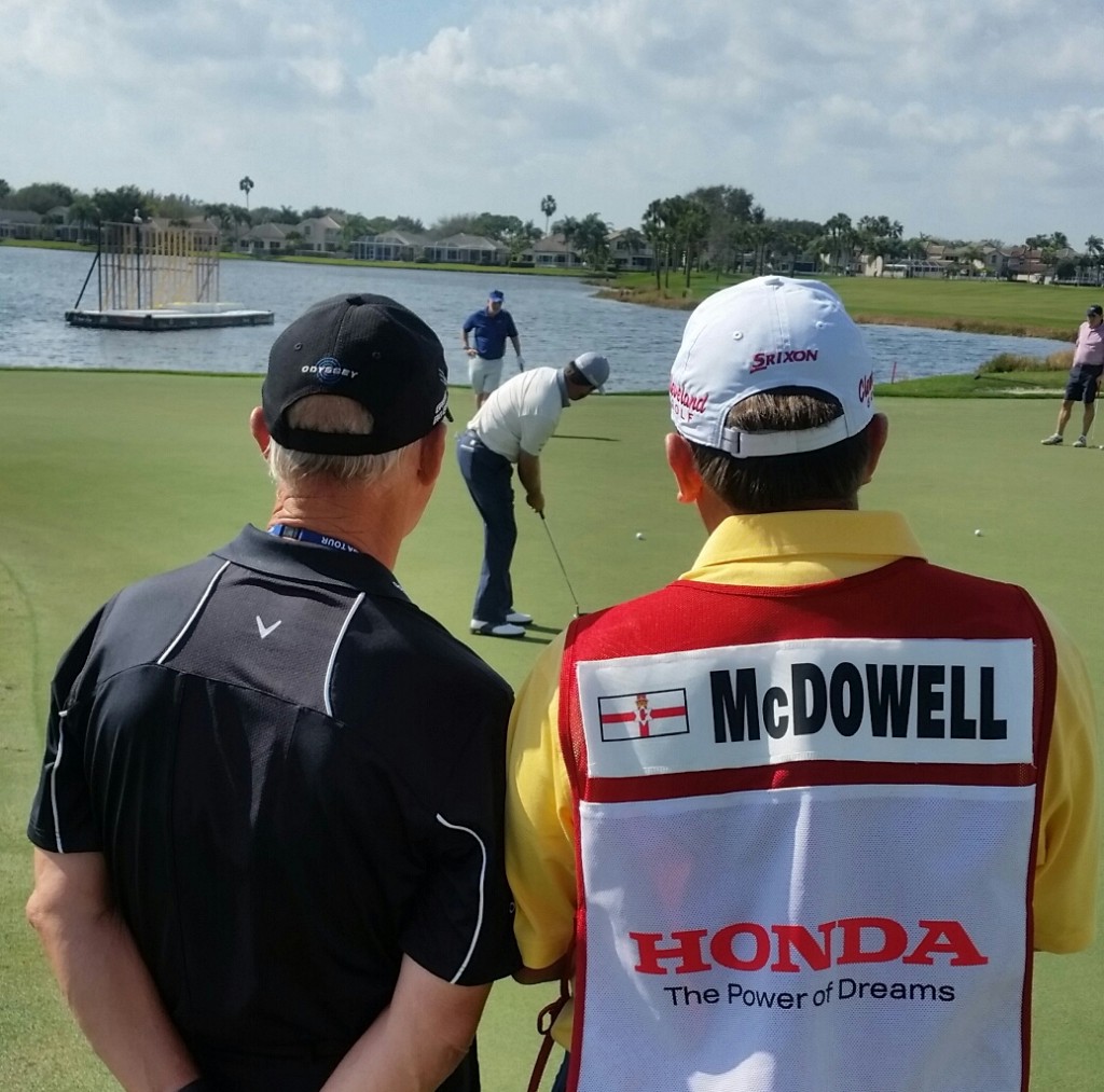 Coach Peter Cowen and caddy Ken Comboy watch on with interest as Graeme McDowell putts out during today's Honda Classic Pro-Am. (Photo - www.golfbytourmiss.com)