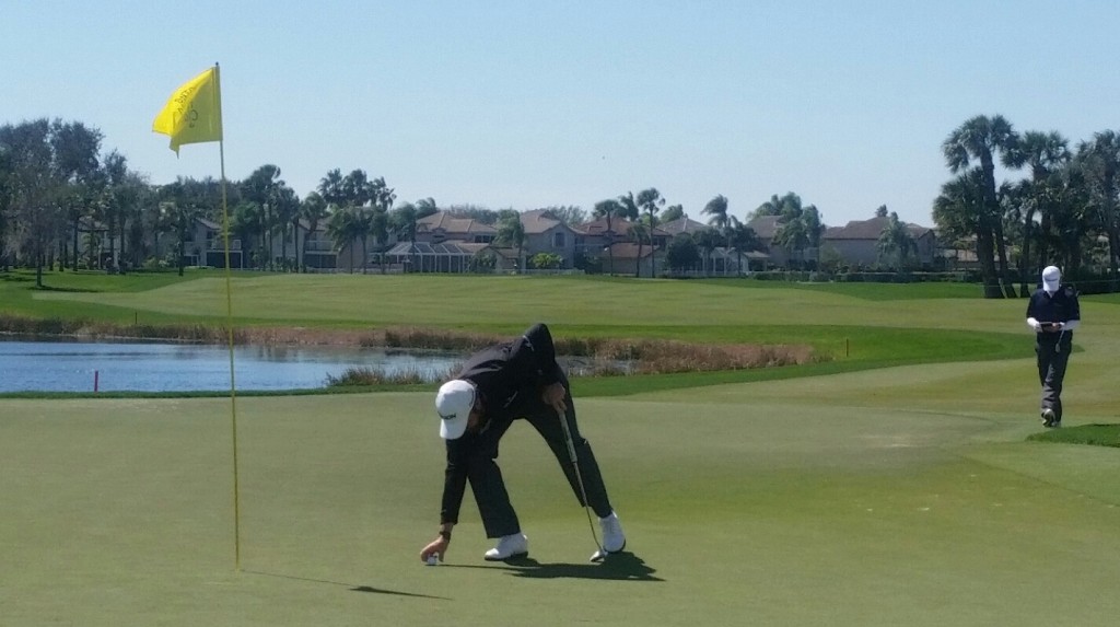 Shane Lowry marking his ball on the 18th after his 243-yard 6-iron shot ahead of holing the four foot putt for birdie. (Photo - www.golfbytourmiss.com)