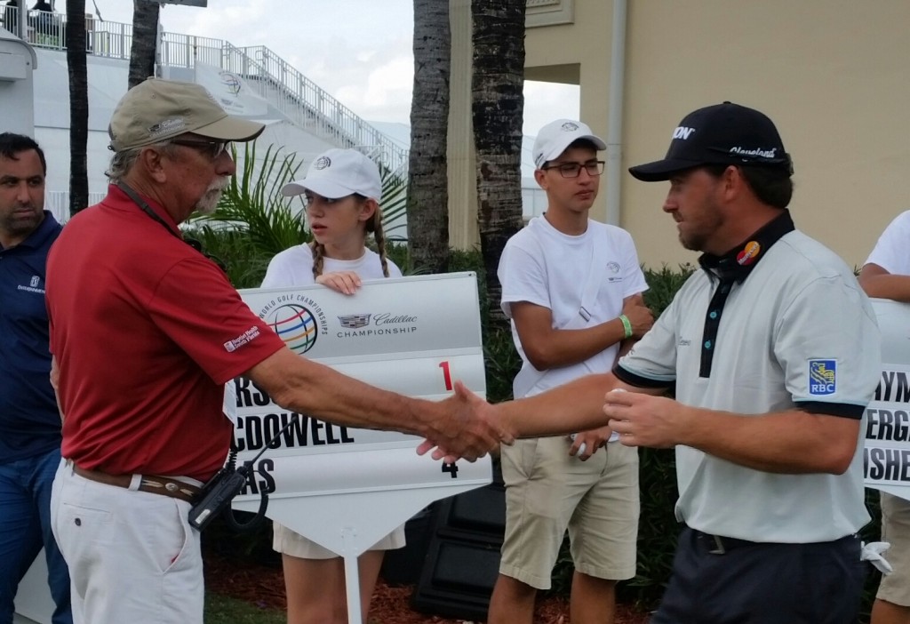 Graeme McDowell presents    the official scorer in his group with an autographed golf ball.