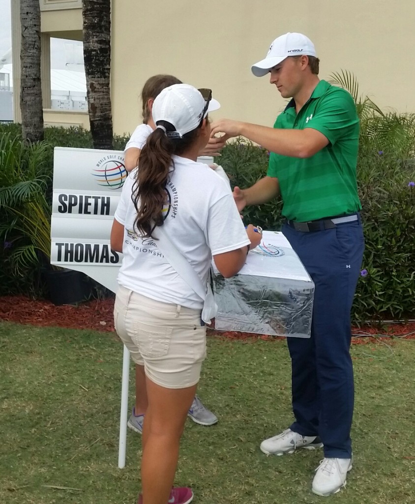 Jordan Spieth delights a young volunteer and presenting here with an autographed golf ball. (Photo - www.golfbytourmiss.com)