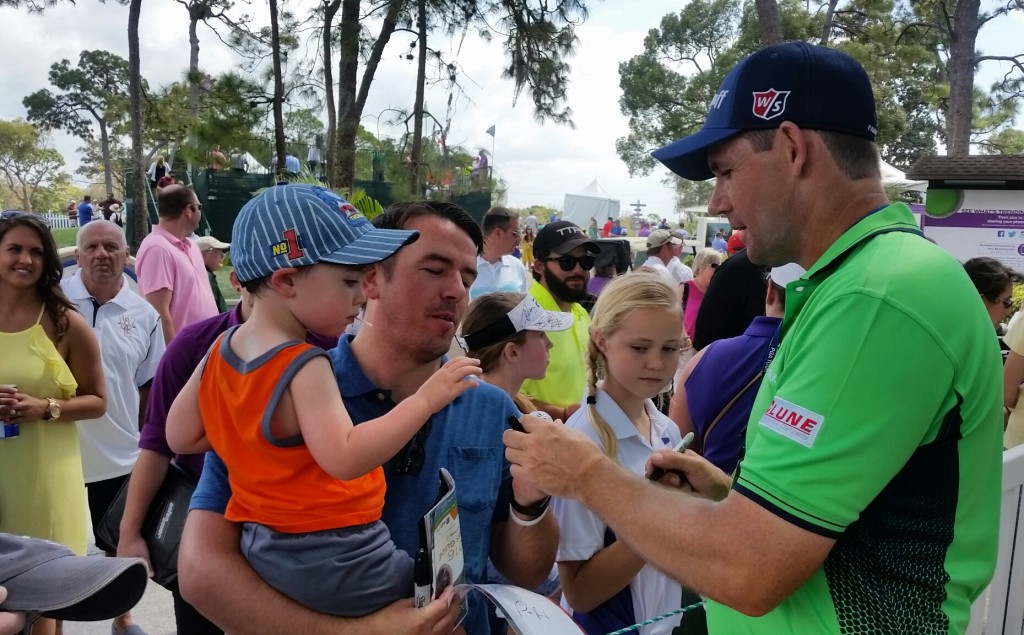 Padraig Harrington happy signing autographs after his round.
