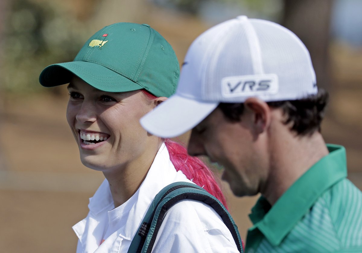 Caroline Wozniacki caddying for Rory McIlroy in 2014 Par 3 Contest at the Masters.