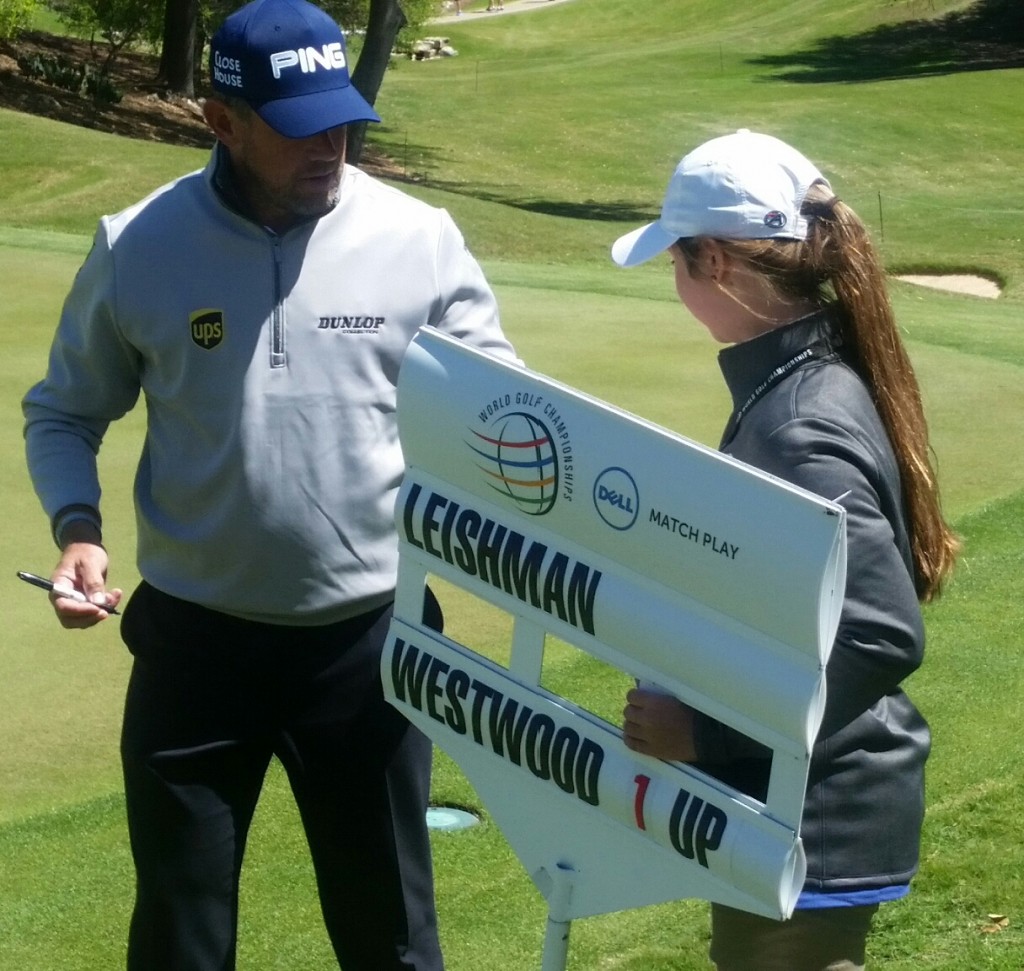 Lee Westwood autographs his ball for a walking scorer after winning his second round match.