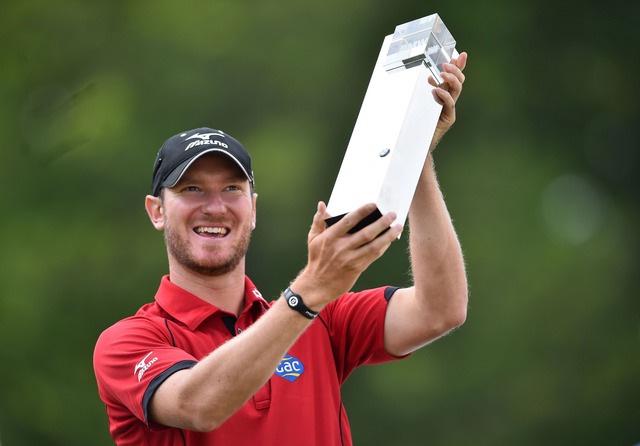 England's Chris Wood proudly lifts the BMW PGA Trophy.