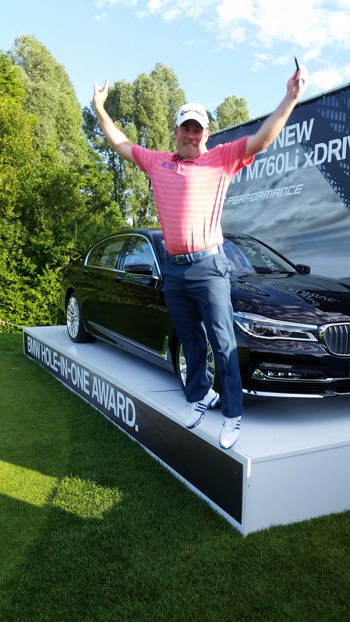 And Richie Ramsay jumps for joy in accepting the key to a Euro 170,000 BMW M760 limo for his ace on day one of the 2016 BMW International Open. (Photo - www.golfbytourmiss.com)