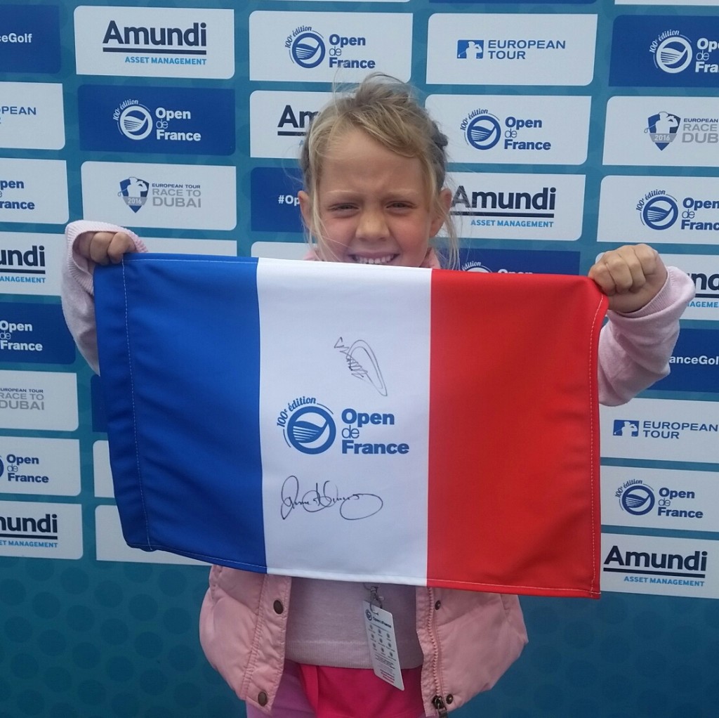 Young Mila proudly holds aloft her French flag signed by Victor Dubuisson and Rory McIlroy. (Photo - www.golfbytourmiss.com)