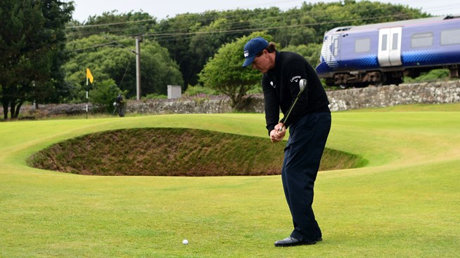 Phil Mickelson chipping into the green at the 11th hole.