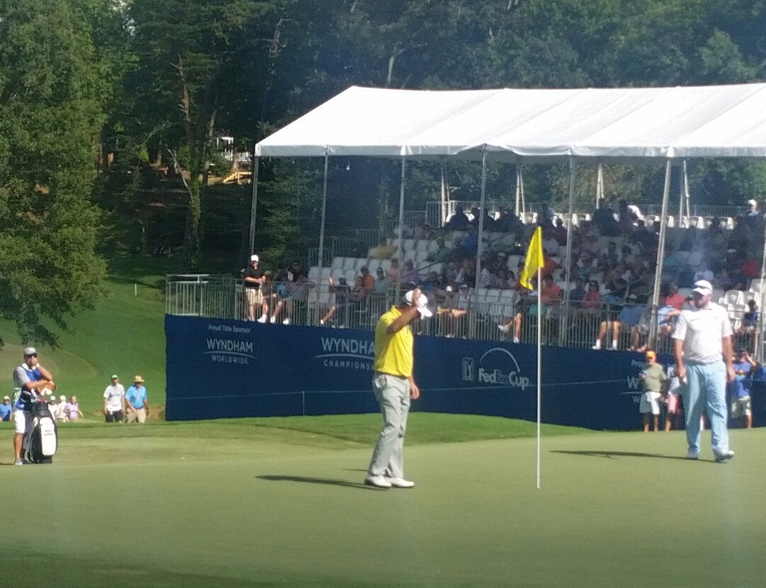 Graeme McDowell acknowledges the crowd after tapping in for a fourth birdie in succession on day three of the Wyndham Championship.
