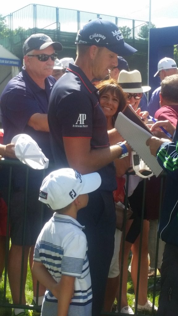 Henrik Stenson and his young son, Karl by his side after posting a three under par 68 on day one of the Deutsche Bank Championship.