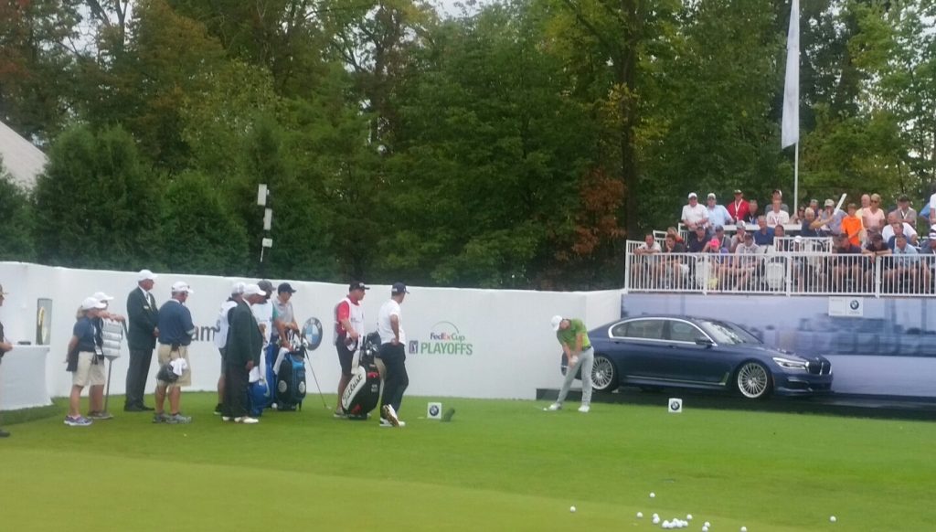 After a 3 hour and 15 minute delay Rory McIlroy finally tees up at 5.23pm local time on day one of the BMW Championship.