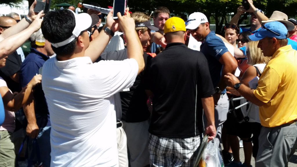 Somewhere in this scrum is World No. 1 Jason Day. (Photo - www.golfbytourmiss.com)