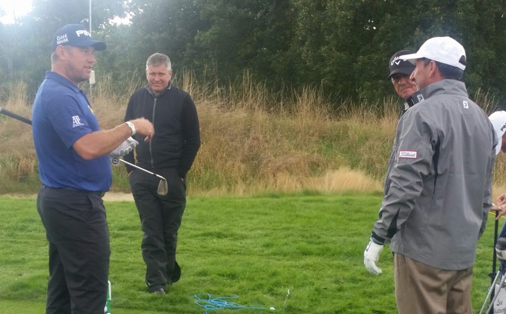 Jose Maria Olazabal greets Lee Westwood on The Grove practice range.