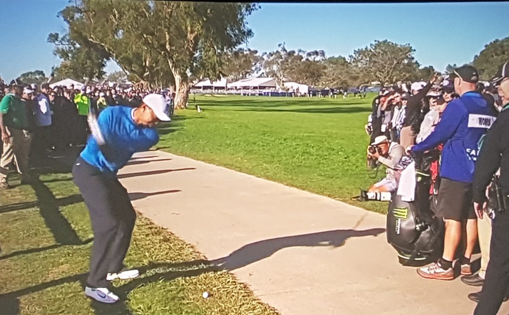 After taking a penalty drop Woods plays his third on route to a double bogey '7' at the 15th hole.