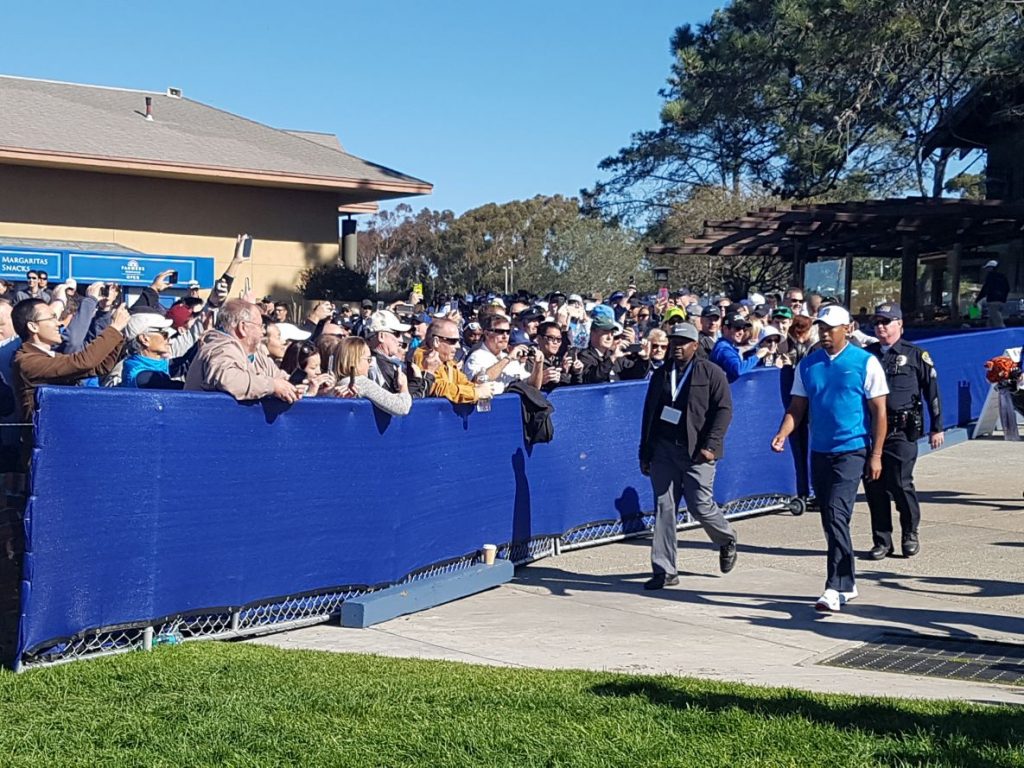 Tiger Woods makes his way to the first tee of his first PGA Tour event in some 17 months.