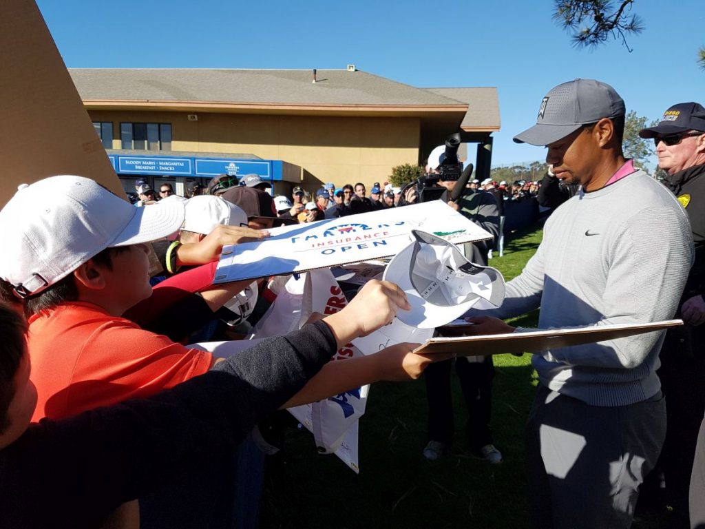 Tiger Woods signs autographs after rounds of 76 and 72 in the 2017 Farmers Insurance Open