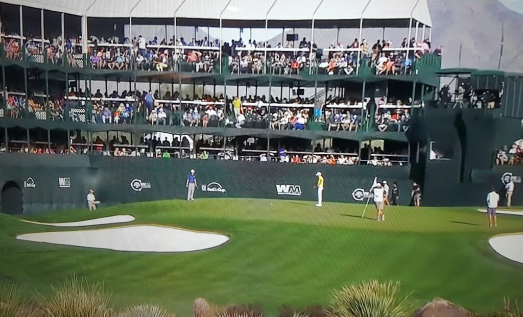 Crowds stacked three stories high watch as Martin Laird lines up his birdie putt