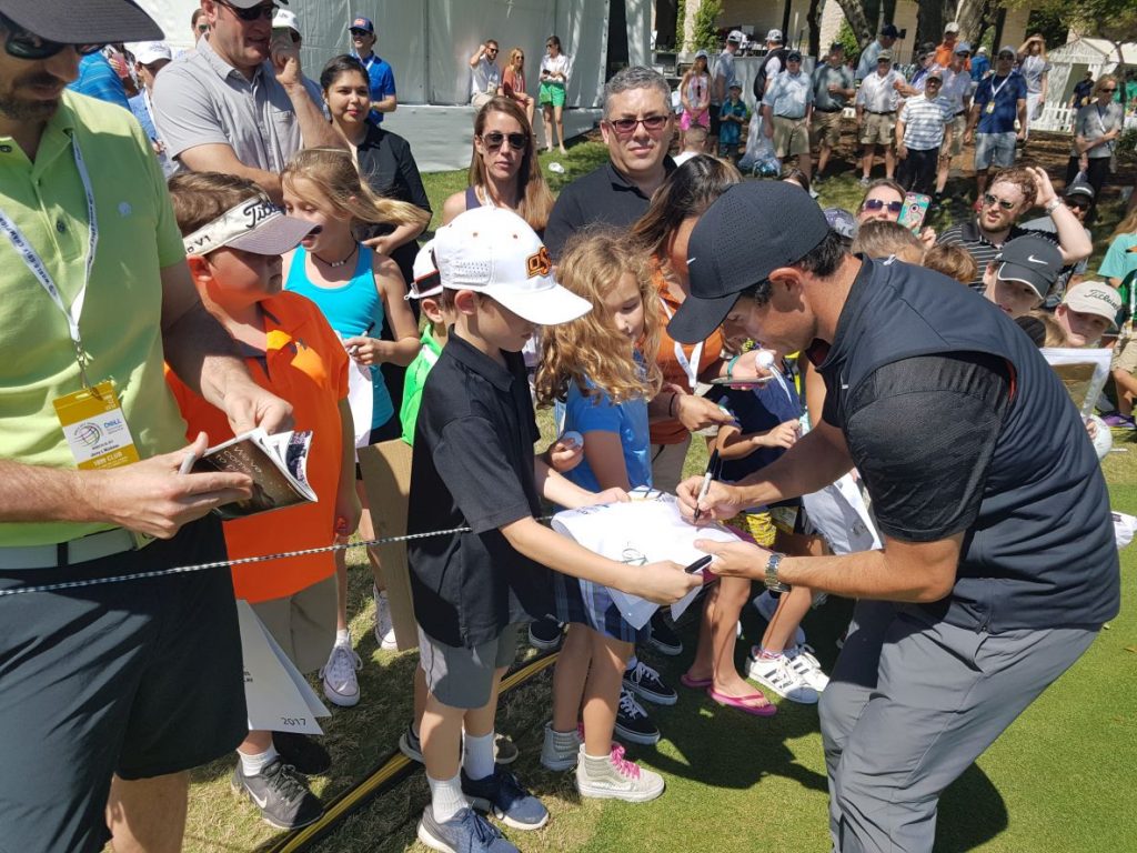 Rory McIlroy signs autographs for his younger fan base.