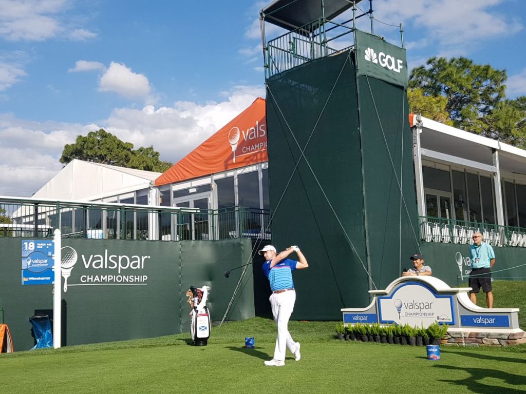 The eyes of his coach and his caddy are on Russell Knox as he drives off the 18th hole in practice ahead of this week's 2017 Valspar Championship.