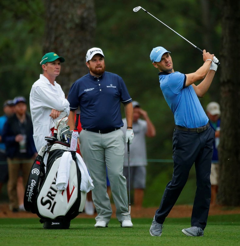 Martin Kaymer of Germany plays from the fairway of No. 1 as Shane Lowry of Ireland looks on during Practice Round 1 for the Masters at Augusta National Golf Club, Monday, April 3, 2017.